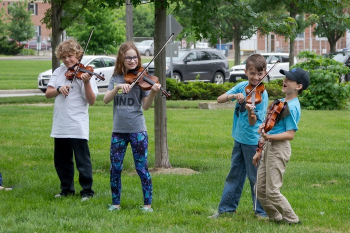 Young Suzuki Center Children Playing Violin Outside