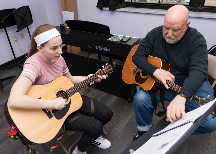 Teen Practicing Private Acoustic Guitar Lessons with Baldwin Wallace Music Teacher