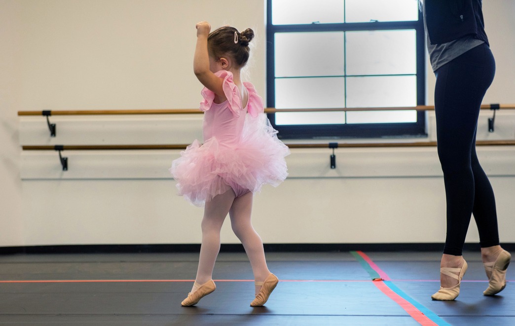 Young Ballet Dancer on Her Tiptoes Mimicking Her Dance Instructor